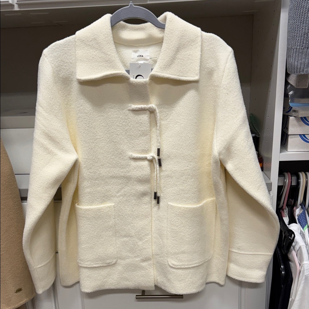 Cream double faced jacket with unique button details.  NWT
